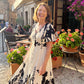 Elegante vestido midi con escote en V y estampado botánico