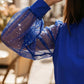 Top con cuello en V y mangas transparentes con lentejuelas