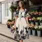 Elegante vestido midi con escote en V y estampado botánico